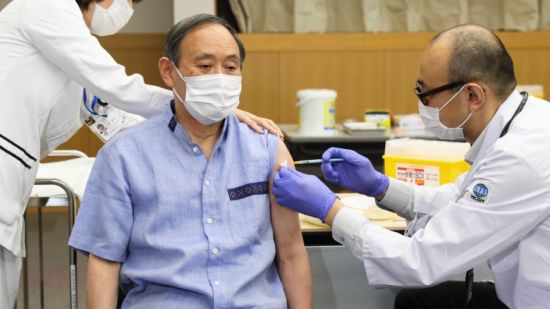 Vaxxed for victory: Prime Minister Suga receives his first dose, March 16, 2021 (Credit: Prime Minister's Office of Japan)