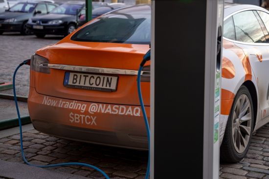 Charging up a crypto-promoting Tesla in Stockholm: Elon Musk's company unloaded 75 percent of its Bitcoin holdings to free up cash in the face of a tight liquidity position (Credit: Boumen Japet / Shutterstock.com)