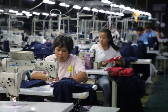 Clothing factory in Henan Province: Will continued Covid-19 lockdowns slow the Chinese economy more than they did in 2020, requiring broad liquidity and labor-market supports? (Credit: He Juan/Xinhua)