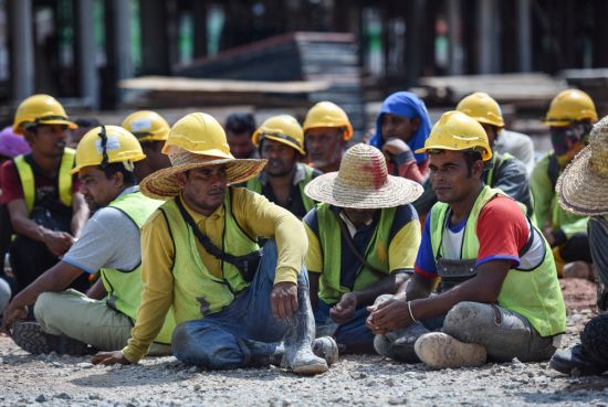 Bangladeshi migrant workers detained by inspectors at a Kuala Lumpur worksite, Jan 2020: Due to their precarious conditions, workers’ vulnerabilities must be addressed to keep them healthy physically and mentally (Credit: Hafiz Johari / Shutterstock.com)