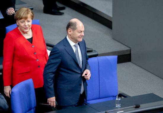 Please take my seat: Social Democrat chancellor-in-waiting Olaf Scholz and Merkel in the Bundestag, Berlin (photocosmos1 / Shutterstock.com)
